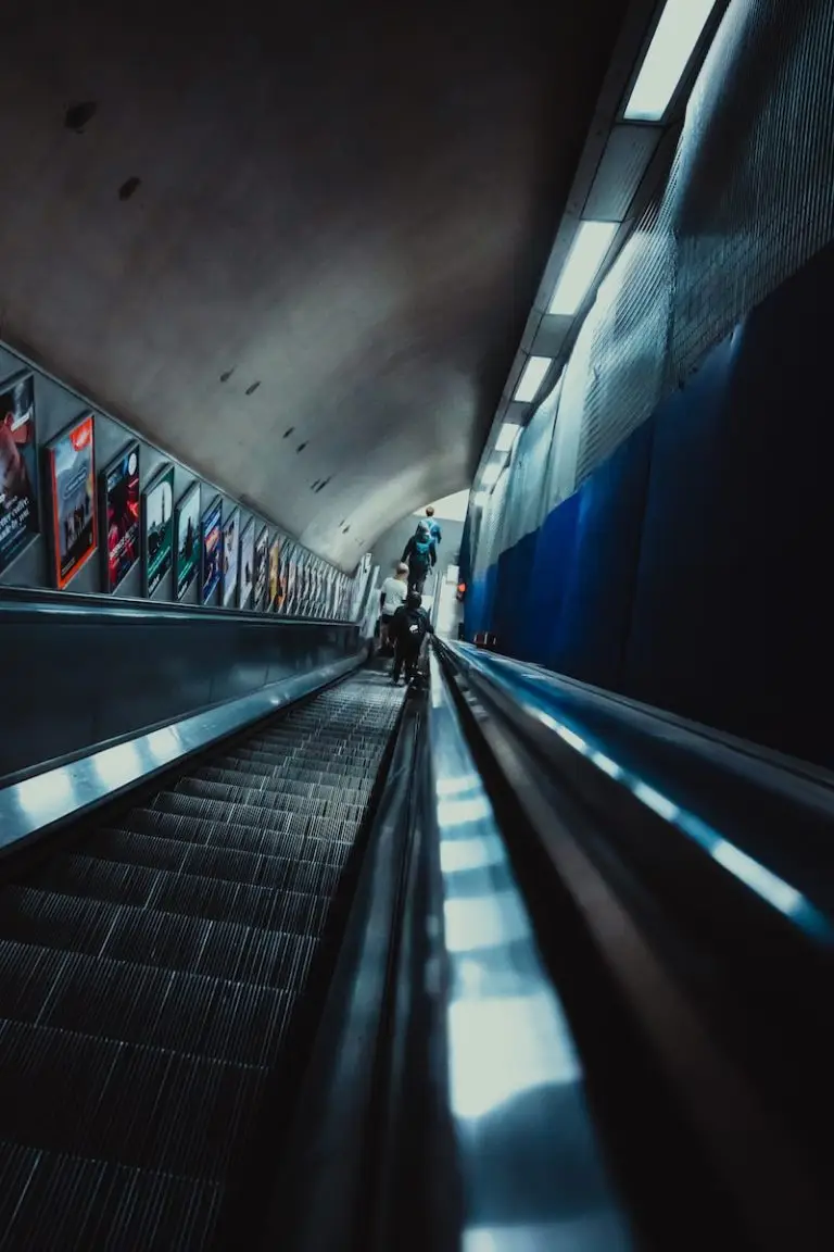 a person riding an escalator in a subway station