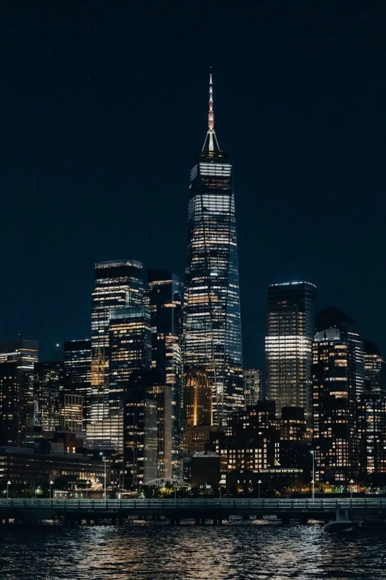 One world trade center illuminating new york city skyline
